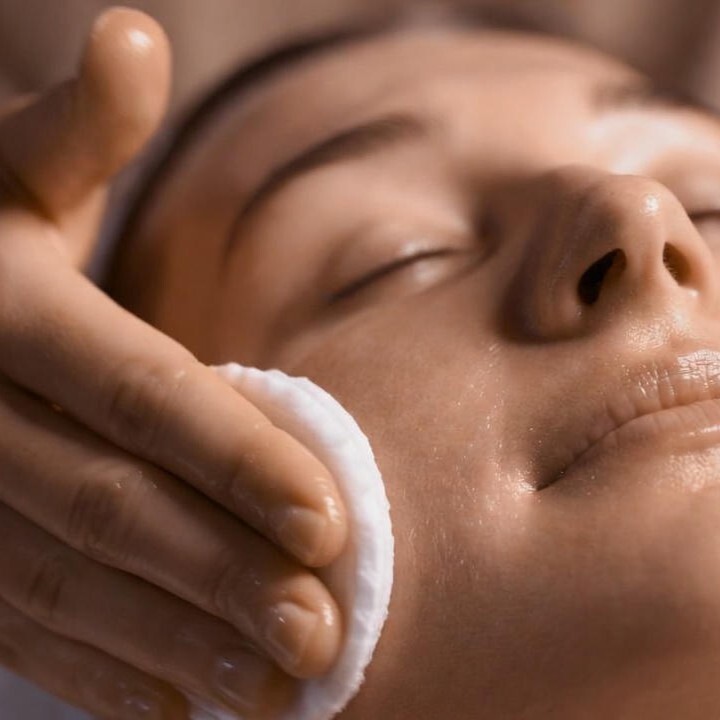 Haut wird vor der Behandlung mit Wattepads gereinigt - Vorbereitung für Microneedling in Wien